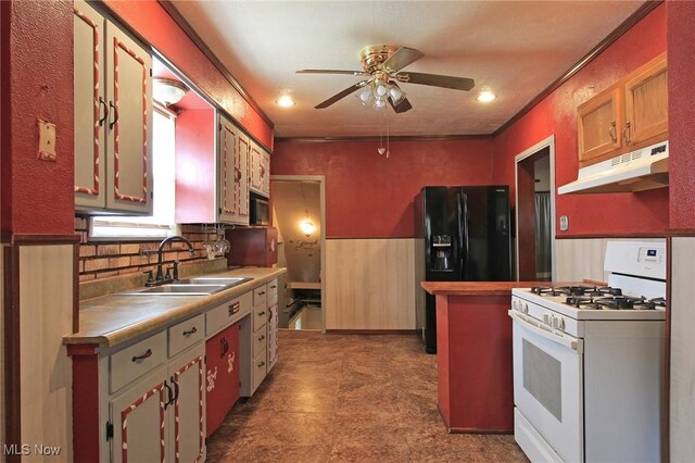 645 N Way St, Barberton, OH 44203 - kitchen with white range with gas stovetop, under cabinet range hood, black fridge with ice dispenser, a sink, and a ceiling fan