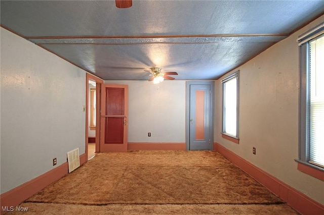 645 N Way St, Barberton, OH 44203 - unfurnished room featuring a ceiling fan, carpet floors, healthy amount of natural light, and a textured ceiling