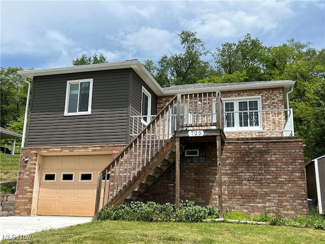 725 Logan Ave, Mingo Junction, OH 43938 - view of front of property with brick siding, stairs, and an attached garage