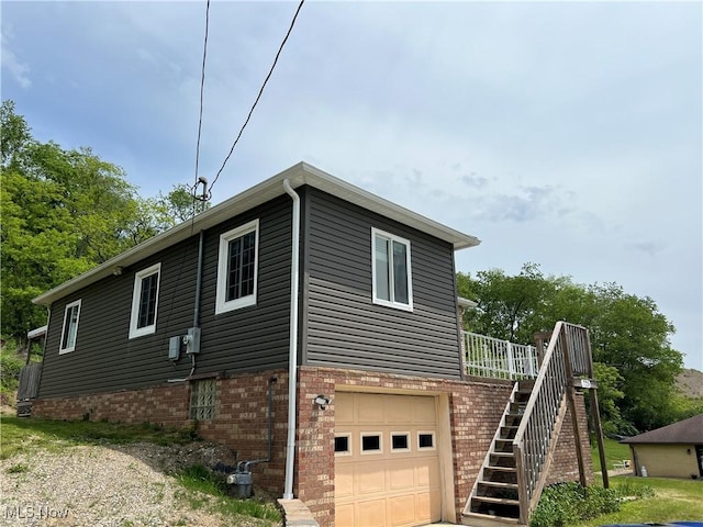 725 Logan Ave, Mingo Junction, OH 43938 - view of property exterior with a garage, stairs, and brick siding