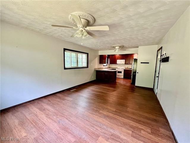 725 Logan Ave, Mingo Junction, OH 43938 - unfurnished living room featuring ceiling fan, baseboards, and dark wood finished floors