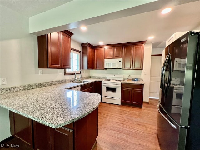 725 Logan Ave, Mingo Junction, OH 43938 - kitchen with white appliances, a sink, a peninsula, light wood-style floors, and recessed lighting