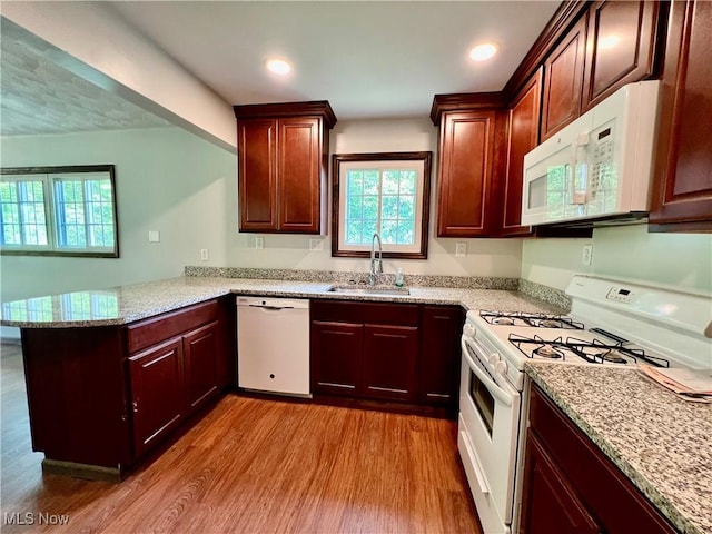 725 Logan Ave, Mingo Junction, OH 43938 - kitchen featuring white appliances, a sink, a peninsula, wood finished floors, and plenty of natural light