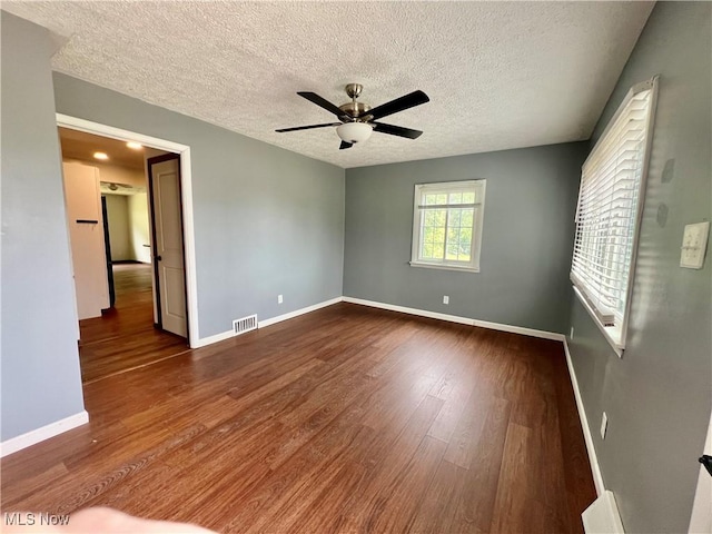 725 Logan Ave, Mingo Junction, OH 43938 - empty room featuring a ceiling fan, a textured ceiling, dark wood finished floors, and baseboards