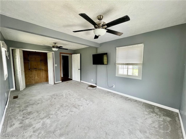 725 Logan Ave, Mingo Junction, OH 43938 - unfurnished bedroom featuring baseboards, a textured ceiling, carpet flooring, multiple closets, and ceiling fan