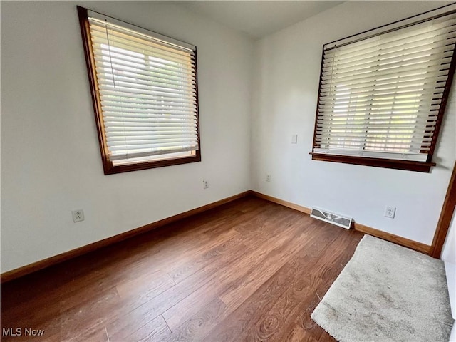 725 Logan Ave, Mingo Junction, OH 43938 - unfurnished room featuring healthy amount of natural light, wood finished floors, and baseboards
