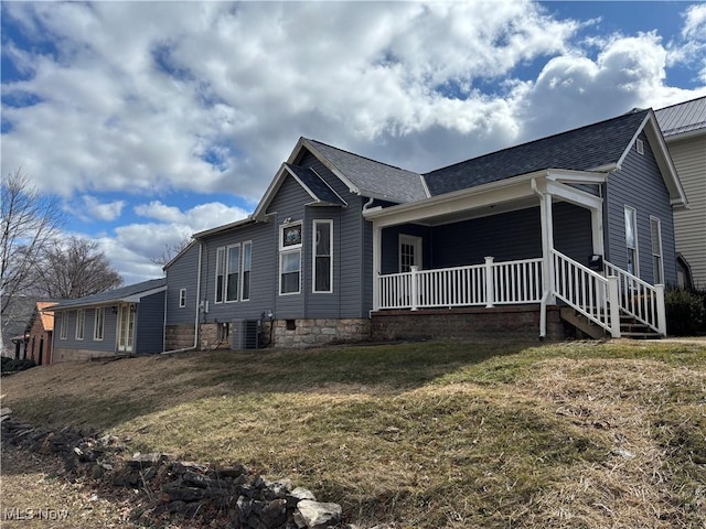 1278 Euclid Ave, Zanesville, OH 43701 - view of side of property featuring covered porch, a shingled roof, a yard, and cooling unit