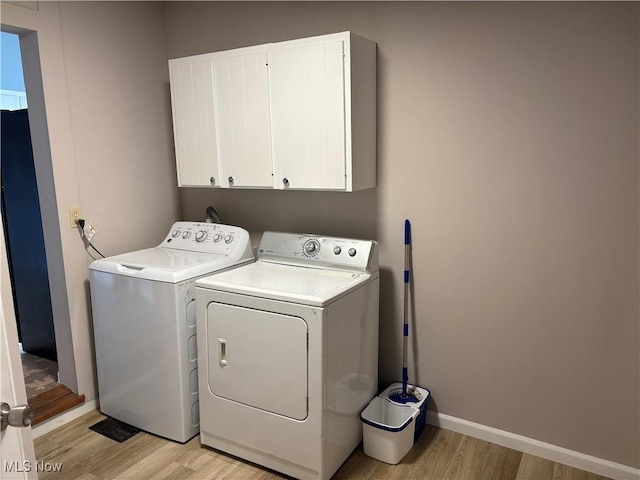 1278 Euclid Ave, Zanesville, OH 43701 - washroom with cabinet space, light wood-style floors, washing machine and clothes dryer, and baseboards