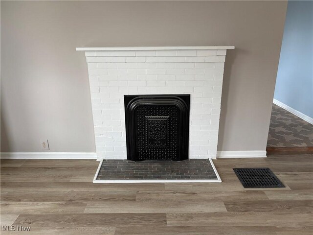 1278 Euclid Ave, Zanesville, OH 43701 - detailed view of wood finished floors, baseboards, and a fireplace