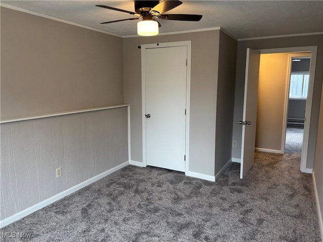 1278 Euclid Ave, Zanesville, OH 43701 - unfurnished bedroom featuring carpet, crown molding, a baseboard heating unit, a ceiling fan, and baseboards