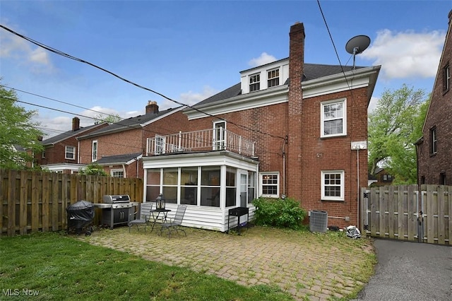 17917 Scottsdale Blvd, Shaker Heights, OH 44122 - back of house featuring a balcony, brick siding, a sunroom, a chimney, and a patio area