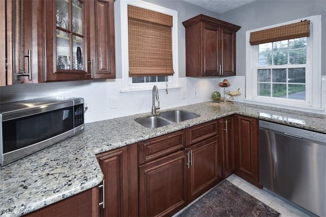 17917 Scottsdale Blvd, Shaker Heights, OH 44122 - kitchen with stainless steel appliances, a sink, decorative backsplash, and light stone countertops