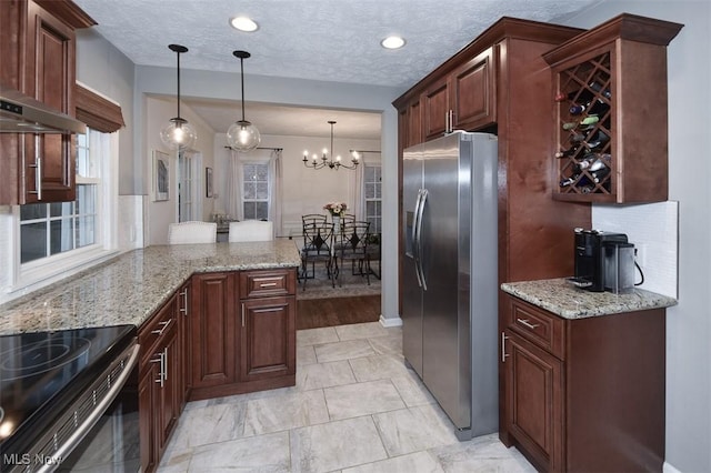 17917 Scottsdale Blvd, Shaker Heights, OH 44122 - kitchen featuring stainless steel appliances, a chandelier, a peninsula, pendant lighting, and light stone counters