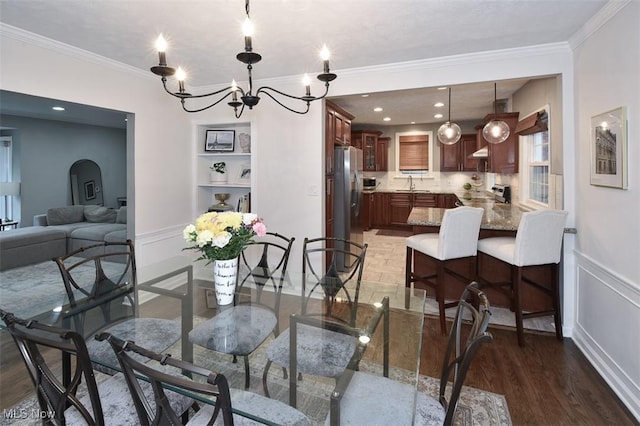 17917 Scottsdale Blvd, Shaker Heights, OH 44122 - dining room with ornamental molding, wood finished floors, a chandelier, wainscoting, and a decorative wall