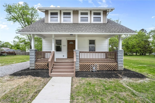 5325 Jefferson Ave, Ashtabula, OH 44004 - view of front of house with a shingled roof, a porch, and a front lawn