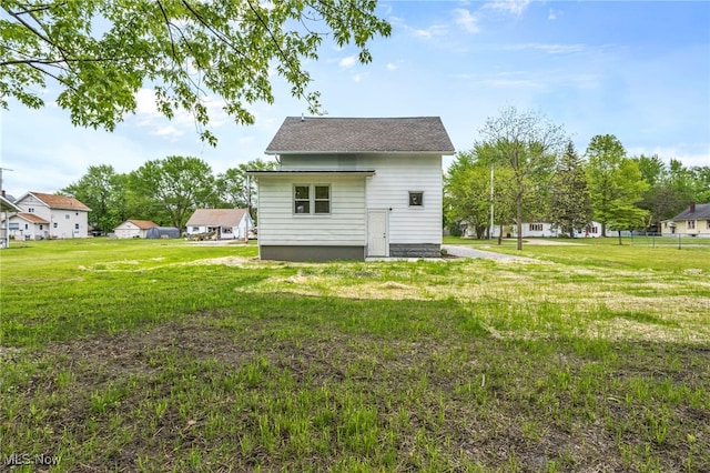 5325 Jefferson Ave, Ashtabula, OH 44004 - rear view of property featuring a yard, a shingled roof, and a residential view