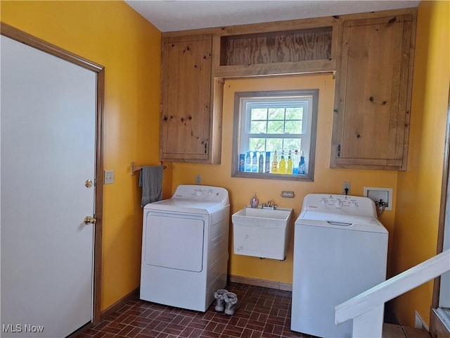 16604 Old State Rd, Middlefield, OH 44062 - laundry area featuring brick patterned flooring, cabinet space, washing machine and clothes dryer, and baseboards