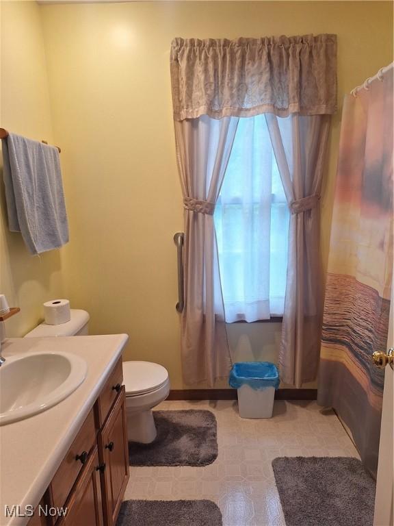 16604 Old State Rd, Middlefield, OH 44062 - full bath featuring toilet, vanity, curtained shower, and tile patterned floors