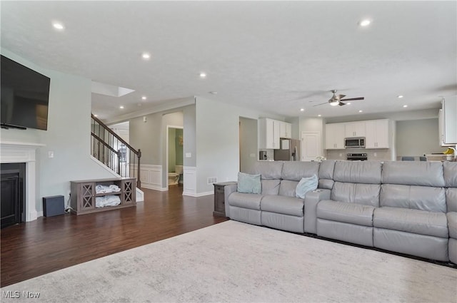 2562 Gianni Way, Richfield, OH 44286 - living room with dark wood-type flooring, recessed lighting, a ceiling fan, stairs, and wainscoting