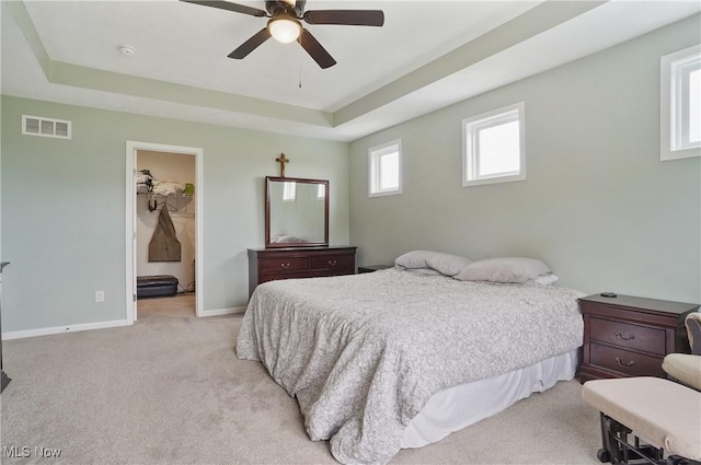 2562 Gianni Way, Richfield, OH 44286 - bedroom featuring a raised ceiling, light colored carpet, baseboards, and a ceiling fan