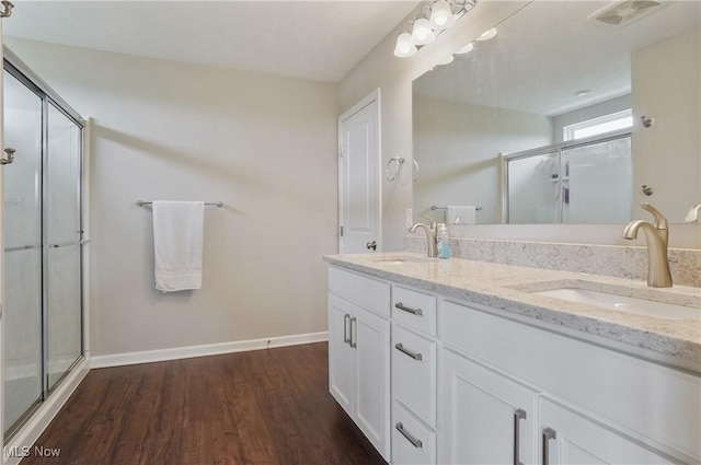 2562 Gianni Way, Richfield, OH 44286 - full bath featuring wood finished floors, double vanity, a shower with door, and baseboards
