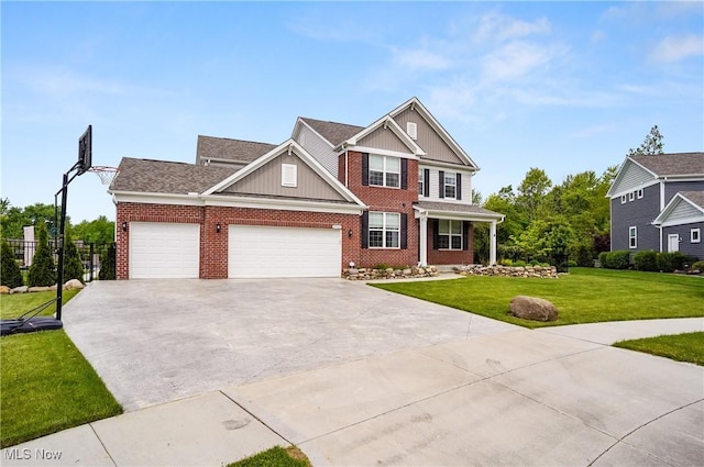 2562 Gianni Way, Richfield, OH 44286 - view of front of house featuring a front yard, brick siding, driveway, a garage, and board and batten siding