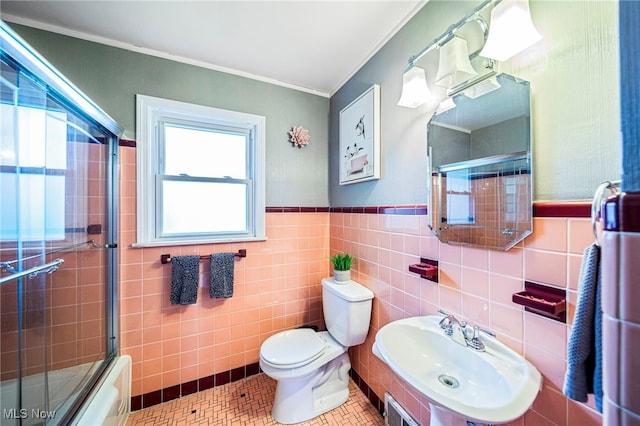 2039 S Green Rd, South Euclid, OH 44121 - bathroom featuring crown molding, toilet, tile walls, a sink, and shower / bath combination with glass door