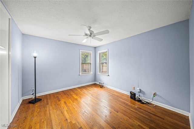 2039 S Green Rd, South Euclid, OH 44121 - spare room with ceiling fan, wood finished floors, a textured ceiling, and baseboards