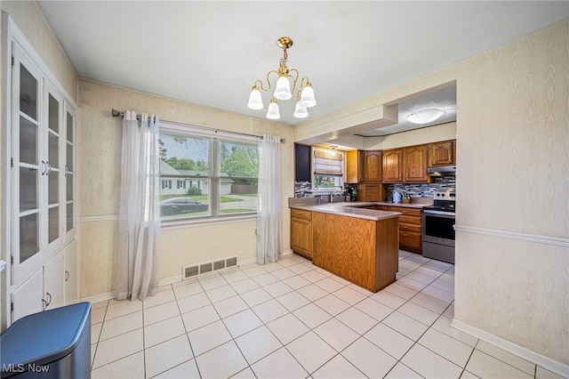 2039 S Green Rd, South Euclid, OH 44121 - kitchen featuring electric stove, a peninsula, brown cabinetry, a chandelier, and light tile patterned flooring
