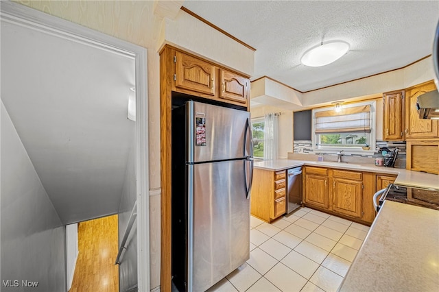2039 S Green Rd, South Euclid, OH 44121 - kitchen featuring appliances with stainless steel finishes, a sink, light countertops, light tile patterned floors, and a textured ceiling