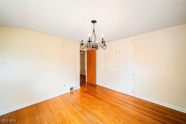 2039 S Green Rd, South Euclid, OH 44121 - spare room with a chandelier, light wood-type flooring, and baseboards