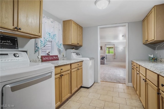 9434 Trinity Church Rd, Lisbon, OH 44432 - laundry room featuring separate washer and dryer, cabinet space, light carpet, baseboards, and light tile patterned floors