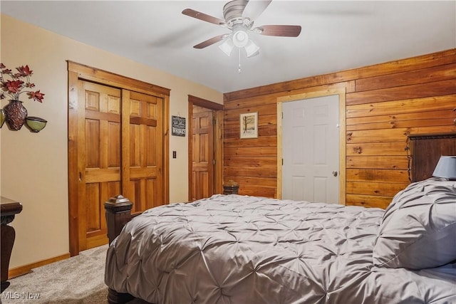 9434 Trinity Church Rd, Lisbon, OH 44432 - bedroom featuring carpet, wood walls, baseboards, a ceiling fan, and a closet