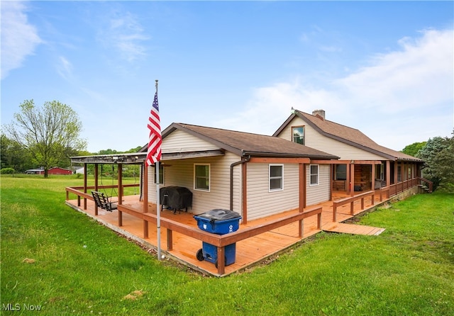 9434 Trinity Church Rd, Lisbon, OH 44432 - rear view of property featuring a wooden deck, a lawn, and a chimney