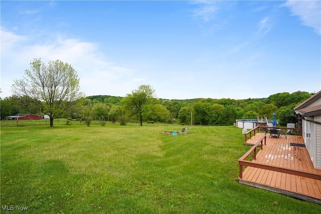 9434 Trinity Church Rd, Lisbon, OH 44432 - view of green lawn featuring a wooden deck and a forest view