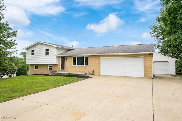 4426 Dueber Ave SW, Canton, OH 44706 - tri-level home featuring brick siding, a garage, a front lawn, driveway, and a shingled roof