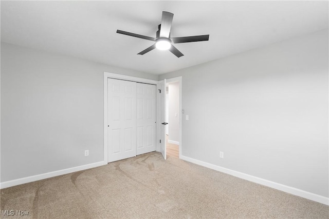 4426 Dueber Ave SW, Canton, OH 44706 - unfurnished bedroom with light colored carpet, baseboards, a closet, and ceiling fan