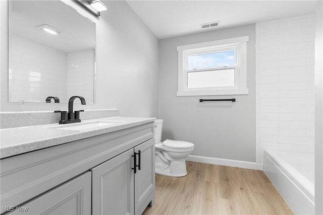 4426 Dueber Ave SW, Canton, OH 44706 - bathroom featuring vanity, toilet, wood finished floors, and baseboards