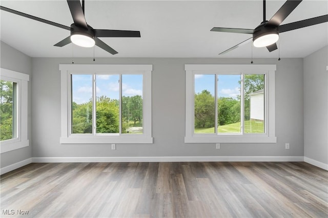 4426 Dueber Ave SW, Canton, OH 44706 - spare room with ceiling fan, wood finished floors, and baseboards