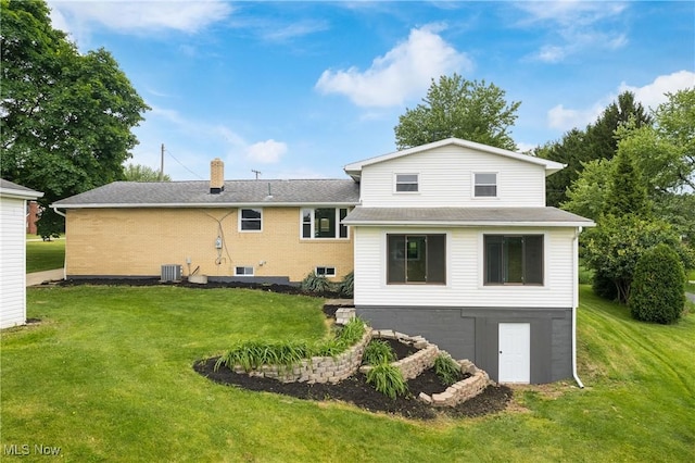 4426 Dueber Ave SW, Canton, OH 44706 - rear view of house with a yard, central AC, a chimney, and a shingled roof