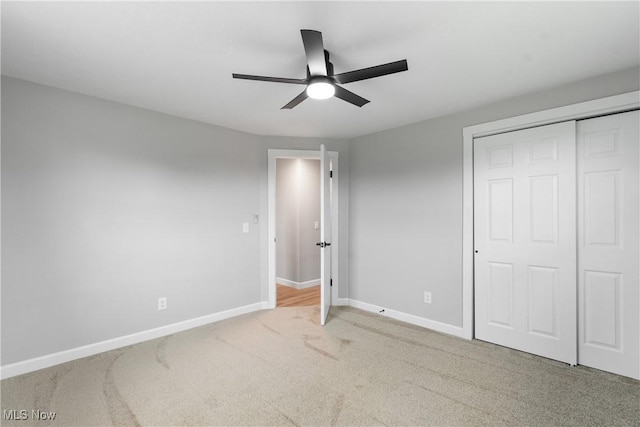 4426 Dueber Ave SW, Canton, OH 44706 - unfurnished bedroom with carpet floors, baseboards, a closet, and a ceiling fan