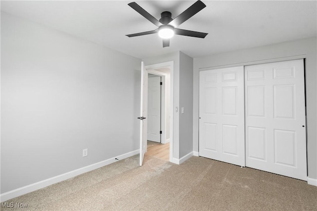 4426 Dueber Ave SW, Canton, OH 44706 - unfurnished bedroom featuring light colored carpet, baseboards, a closet, and a ceiling fan
