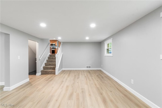 4426 Dueber Ave SW, Canton, OH 44706 - below grade area featuring recessed lighting, stairs, light wood finished floors, and baseboards