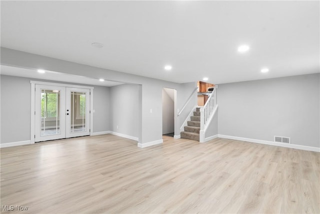 4426 Dueber Ave SW, Canton, OH 44706 - unfurnished living room with french doors, light wood-style floors, recessed lighting, stairway, and baseboards