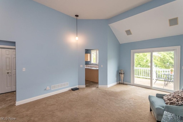 83 Haskell Dr, Bratenahl, OH 44108 - living area with light colored carpet, baseboards, and high vaulted ceiling