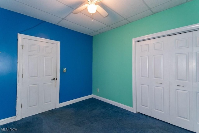 83 Haskell Dr, Bratenahl, OH 44108 - unfurnished bedroom with dark colored carpet, a paneled ceiling, a closet, baseboards, and a ceiling fan