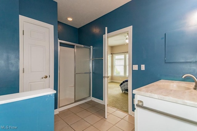 83 Haskell Dr, Bratenahl, OH 44108 - ensuite bathroom with vanity, a shower stall, tile patterned flooring, baseboards, and a ceiling fan