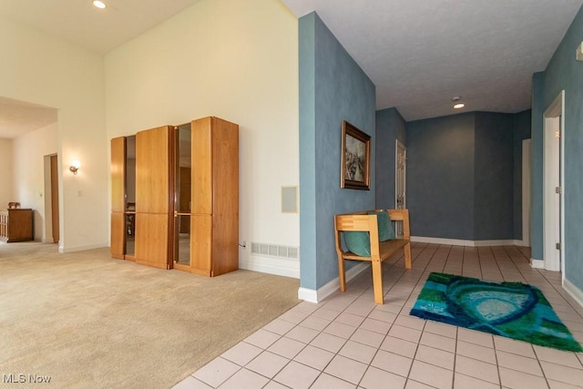 83 Haskell Dr, Bratenahl, OH 44108 - corridor with baseboards, light carpet, a towering ceiling, recessed lighting, and light tile patterned floors