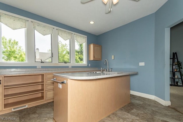 83 Haskell Dr, Bratenahl, OH 44108 - kitchen with a kitchen island with sink, light countertops, a sink, baseboards, and ceiling fan