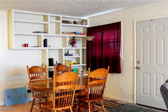 2007 W 59th St, Ashtabula, OH 44004 - dining area featuring a textured ceiling and baseboards